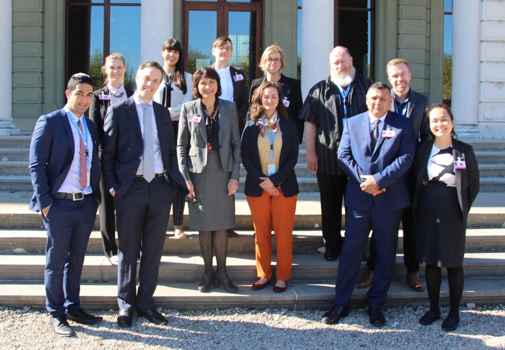 NGO delegation members stand outside Palais Wilson, Geneva